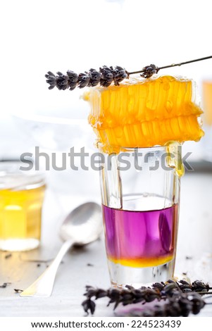 Martini, lavender, honey, lemon cocktail on a white background.