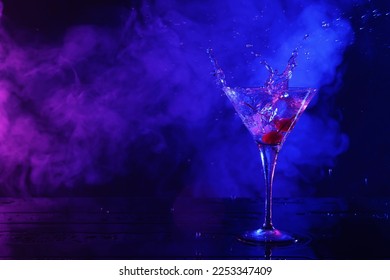 Martini splashing out of glass in neon lights, space for text - Powered by Shutterstock