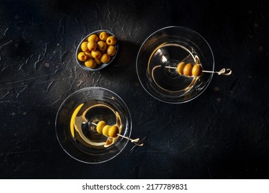 Martini, Two Glasses With Spicy Olives, On A Black Background. Alcoholic Cocktails, Overhead Flat Lay Shot