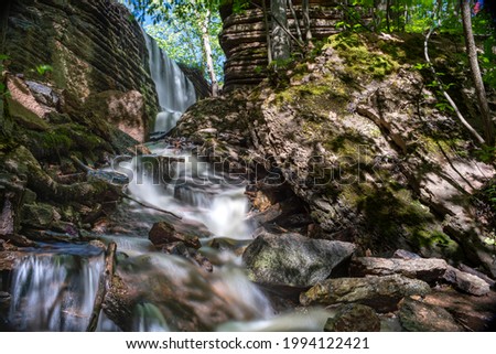 Martorpsfallet Waterfall, Delicate creek decending in lush forest on wet limestone rock on Kinnekulle nature reserve, Sweden.