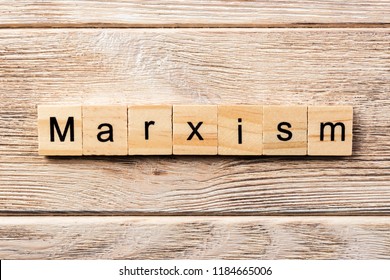 Marxism Word Written On Wood Block. Marxism Text On Table, Concept.