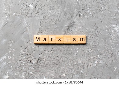 Marxism Word Written On Wood Block. Marxism Text On Table, Concept.