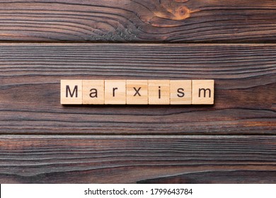 Marxism Word Written On Wood Block. Marxism Text On Table, Concept.