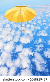 Mary Poppins Umbrella.Yellow umbrella flies in sky against of white clouds.Wind of change concept.