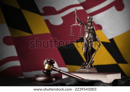 Maryland US state flag with statue of lady justice, constitution and judge hammer on black drapery. Concept of judgement and punishment