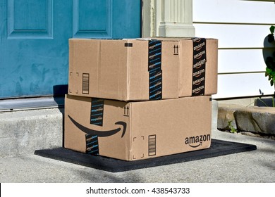 MARYLAND, USA - JUNE 17, 2016: Amazon Prime boxes delivered to the front door of a home. Amazon is the largest Internet-based retailer in the United States.