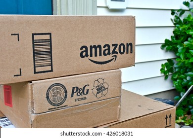 MARYLAND, USA - MAY 24, 2016: Amazon boxes delivered to a residential home. Amazon is the largest internet based retailer in the United States.