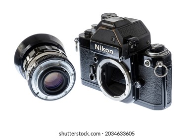 Maryville, Tennessee, United States – August 27, 2021: Horizontal angled front shot of a black Nikon F2S single-lens reflex camera body with a detached lens isolated on white. 