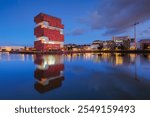 MAS museum, Antwerp, Belgium. Cityscape during sunset.  Reflection on the water surface. MAS museum near the water in the bay. Architecture of the Belgium. Travel photography.