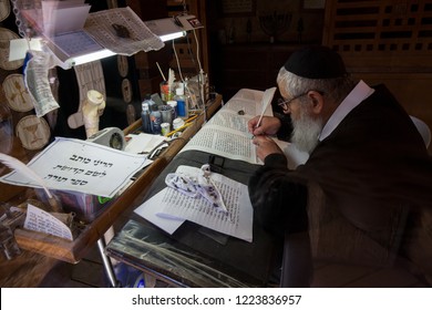 Masada, Israel - 21 February 2018: Jewish biblical scholar overwriting the torah scrolls in the old synagogue on the Masada mountain in Israel