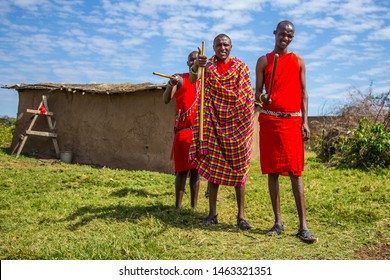 Masai Mara, Kenya »; August 2018: Three Masais Greeting Tourists