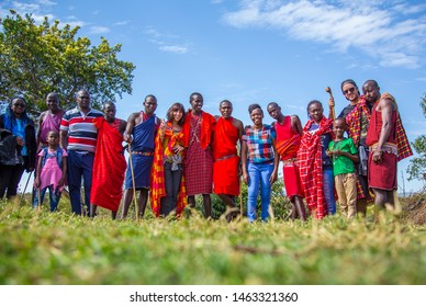 Masai Mara, Kenya »; August 2018: Local And Caucasian Tourists With Young Masais