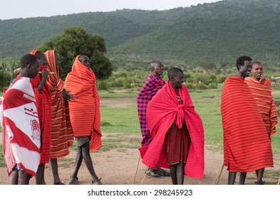 MASAI MARA NATIONAL PARK, KENYA - JUNE 28, 2014. Warriors From Masai Tribe Meeting Tourists In Masai Village