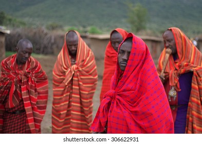 MASAI MARA NATIONAL PARK, KENYA - JUNE 28, 2014. Warriors From Masai Tribe Meeting Tourists In Masai Village