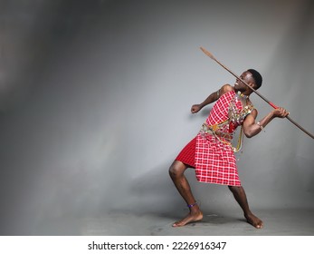 masai warrior about to throw his spear furiously.Grey mockup space.Huge blank background space.Copy text and paste 