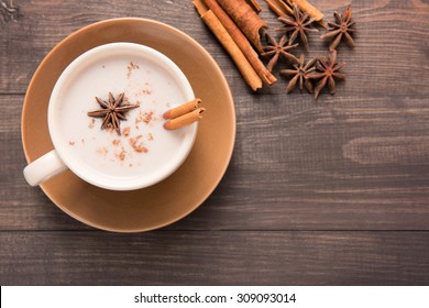 Masala chai with spices cinnamon , cardamom, ginger, clove and star anise on wooden background. - Powered by Shutterstock