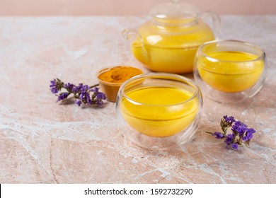 Masala Haldi Doodh. Healthy Golden Milk With Turmeric And Honey On A Beige Marble Background.