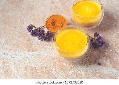 Masala Haldi Doodh. Healthy  Golden Milk With Turmeric And Honey On A Beige Marble Background.