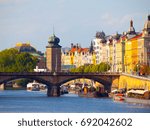 Masaryk Embankment with and Sitkovska water tower Palacky Bridge over Vltava River in Prague city centre, Czech Republic.