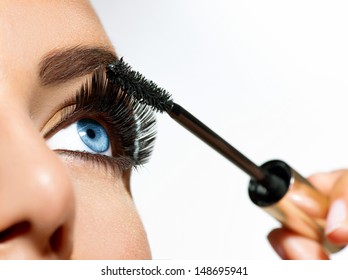 Mascara Applying. Long Lashes closeup. Mascara Brush. Eyelashes extensions. Makeup for Blue Eyes. Eye Make up Apply