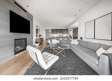 Condominio masculino contemporáneo Sala de estar con vista al mar Pacífico Noroeste Playa y lado del mar Sofá seccional gris Área de carbón Alfombra Silla de cuero blanco Chimenea Televisión montada en la pared