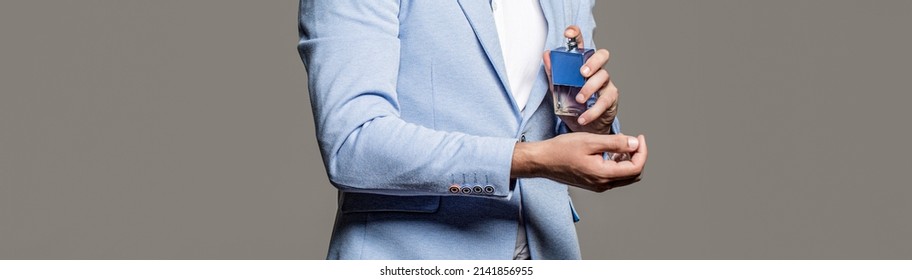 Masculine Perfume, Bearded Man In A Suit. Man Perfume, Fragrance. Male Holding Up Bottle Of Perfume. Perfume Or Cologne Bottle And Perfumery, Cosmetics, Scent Cologne Bottle, Male Holding Cologne.