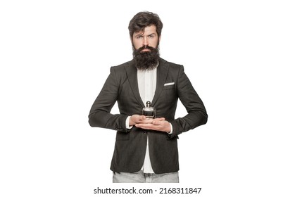 Masculine perfume, bearded man in a suit. Male holding up bottle of perfume. Man perfume, fragrance. Perfume or cologne bottle and perfumery, cosmetics, scent cologne bottle, male holding cologne.