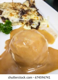 Mash Potato Scoop With Gravy Sauce Topping Serve With Steak.