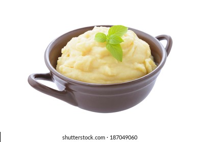 Mashed potato in brown ceramic bowl on white background