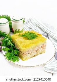 Mashed Potato Casserole With Salmon Fillet And Lettuce In A Plate, Napkin, Garlic On A Wooden Board Background