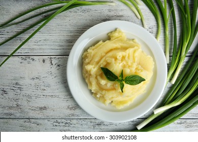 Mashed potatoes in plate on wooden table, top view