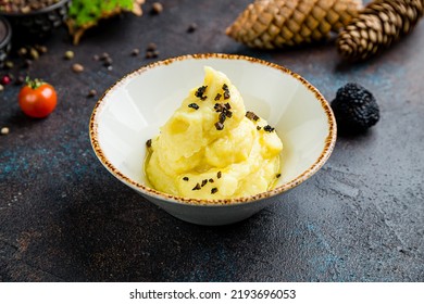 mashed potatoes with truffle on bowl on dark table - Shutterstock ID 2193696053