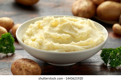 Mashed potatoes in white bowl on wooden rustic table. Healthy food - Shutterstock ID 1443621920