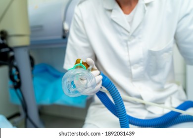 Mask for anesthesia in operating room. Unrecognizible doctor holds mask in hands. Closeup. - Shutterstock ID 1892031439