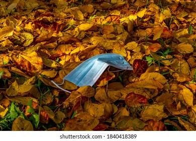 Mask in autumn leaves during Corona