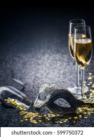 mask and champagne with star shaped confetties