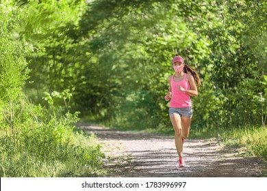 Mask Corona Virus COVID-19 Running Runner Athlete Wearing Mask Jogging Outside On Run Workout In Summer Park Nature. Sport Lifestyle Asian Young Woman.