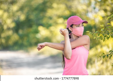 Mask Covid-19 Runner Woman Stretching Arms Before Cardio Workout On Outdoor Summer Park Run Jogging Wearing Face Covering Protection For Coronavirus.