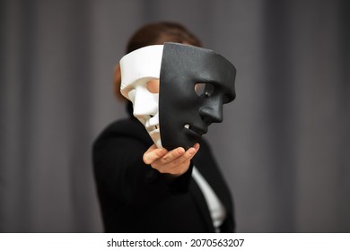 mask drama and comedy in theatre holds the actor before going out to the stage for play performance, chooses between a black and white hero - Shutterstock ID 2070563207