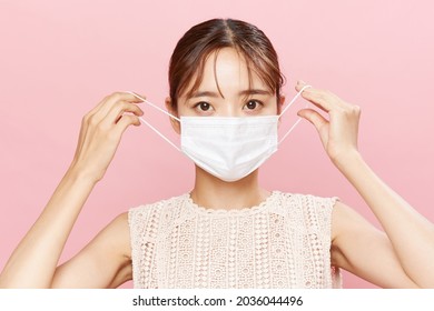 Mask face of a young Asian woman - Powered by Shutterstock