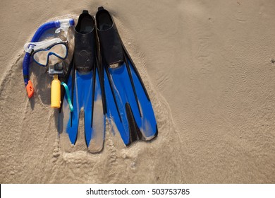 Mask And Flippers On Sand