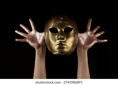 Mask hiding identity with dramatic hands gesture. Mask symbolizing anonymity and secrecy concept. Mask expressing dual personality and inner conflict. Mask representing hidden truth and mystery.