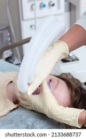 A Mask With Oxygen On The Child's Face. The Child Is Under Anesthesia. Surgery Under General Anesthesia. Vertical Photo. Saving A Child's Life.