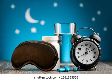 Mask, Pills And Alarm Clock On Night Sky Background. How To Beat Insomnia And Restore Sleeping Routine.