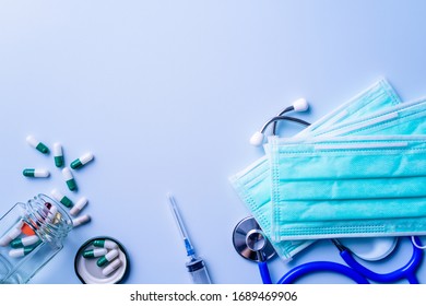 Mask With Pills, Stethoscope, Syringe Medical Supply Objects Isolated On Blue Background, Top View, Flat Lay, Overhead Shot, Virus Protection Concept.