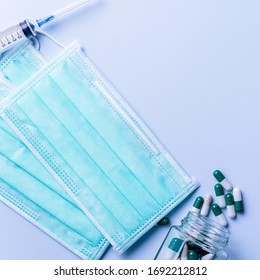 Mask With Pills, Stethoscope, Syringe Medical Supply Objects Isolated On Blue Background, Top View, Flat Lay, Overhead Shot, Virus Protection Concept.