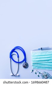 Mask With Pills, Stethoscope, Syringe Medical Supply Objects Isolated On Blue Background, Top View, Flat Lay, Overhead Shot, Virus Protection Concept.