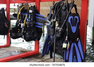  Mask And Scuba Diving Equipment On Wood Table In Caribbean Sea Wit Boat At Background 