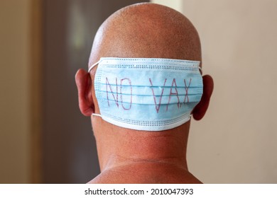 Mask with the words No Vax on the man's head.  Vaccine refusal. Virus Covid-19 vaccination opponents concept.