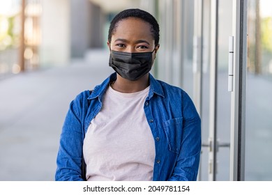 Masked african-american woman on a city street. Teenage girl patient, copy space. Epidemic, pandemic, corona virus protection, healthy lifestyle, people concept - Powered by Shutterstock